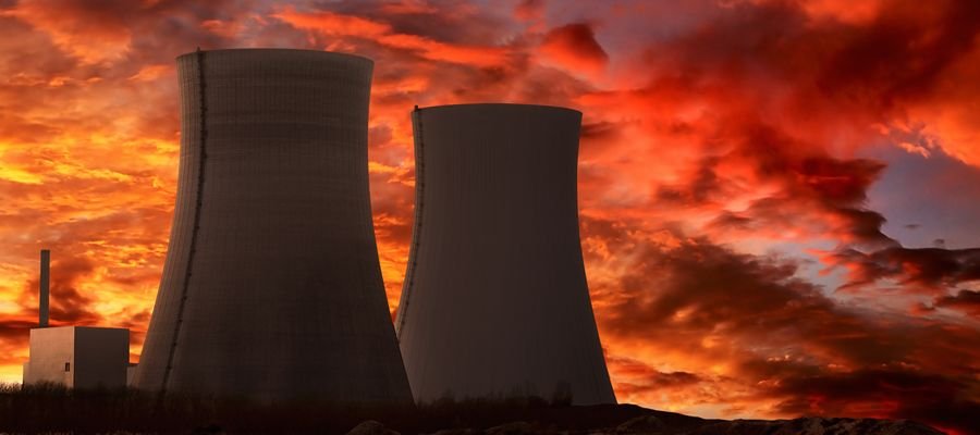 Two nuclear power plants under a sunset